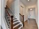Hallway with hardwood floors and staircase featuring dark wood and iron railings at 3695 Andover St, Cumming, GA 30028