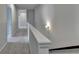 Neutral hallway with gray walls, white trim, plush carpet, and decorative sconce lighting at 3695 Andover St, Cumming, GA 30028