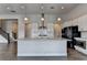 Modern kitchen with a center island, stainless appliances, pendant lights, and sleek countertops at 3695 Andover St, Cumming, GA 30028