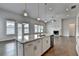 Open kitchen features a large island, stainless steel appliances, and a seamless flow to the living area at 3695 Andover St, Cumming, GA 30028