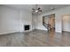 Spacious living room with hardwood floors, a brick fireplace, and a view of the staircase at 3695 Andover St, Cumming, GA 30028