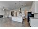Spacious open-concept kitchen and living area with hardwood floors and modern lighting at 3695 Andover St, Cumming, GA 30028