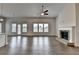 Bright, open living room featuring a brick fireplace, hardwood floors, and lots of natural light at 3695 Andover St, Cumming, GA 30028