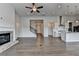 Open-concept living room with a fireplace, kitchen island, and hardwood floors throughout at 3695 Andover St, Cumming, GA 30028