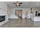 Open-concept living room with a fireplace, kitchen island, and hardwood floors at 3695 Andover St, Cumming, GA 30028