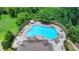 Aerial view of a kidney shaped community pool surrounded by chairs and umbrellas at 3695 Andover St, Cumming, GA 30028