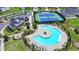 Aerial view of a community pool and tennis courts with lounge chairs and manicured landscaping at 3695 Andover St, Cumming, GA 30028
