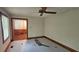Bedroom with wood trim, ceiling fan, and view to hall at 4055 Haralson Mill Ne Rd, Conyers, GA 30012