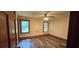 This cozy bedroom features wood-look floors, two windows, and wood trim at 4055 Haralson Mill Ne Rd, Conyers, GA 30012