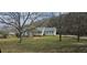 Charming one-story home with a well-manicured lawn and mature trees providing shade at 4055 Haralson Mill Ne Rd, Conyers, GA 30012