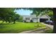 Attractive home featuring a side-entry garage, a quaint front porch, and a verdant lawn at 4055 Haralson Mill Ne Rd, Conyers, GA 30012