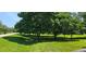 The front lawn of this property has lush green grass and beautiful mature trees at 4055 Haralson Mill Ne Rd, Conyers, GA 30012