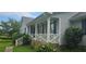Inviting front porch with white railing, blue shutters, and landscaping, offering a cozy curb appeal at 4055 Haralson Mill Ne Rd, Conyers, GA 30012