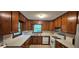 Efficient kitchen with wooden cabinets, white countertops, and standard appliances in a cozy design at 4055 Haralson Mill Ne Rd, Conyers, GA 30012