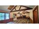 Open living room with wood-look floors, vaulted ceilings, and a cozy fireplace focal point at 4055 Haralson Mill Ne Rd, Conyers, GA 30012