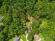 Aerial view of the home surrounded by dense trees and lush landscaping at 169 Knights Ct, Dallas, GA 30157