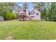 Expansive backyard with lawn, lush trees, and multilevel deck for outdoor enjoyment at 169 Knights Ct, Dallas, GA 30157