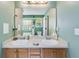 A bathroom with a dual sink vanity and a large mirror at 169 Knights Ct, Dallas, GA 30157