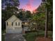 Charming two-story home with a manicured front yard and attached two-car garage and lush landscaping during dusk at 169 Knights Ct, Dallas, GA 30157