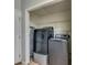 Modern laundry room with front load washer and dryer, shelving and ironing board at 169 Knights Ct, Dallas, GA 30157