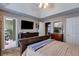 A main bedroom featuring a tray ceiling and an attached en suite bathroom at 169 Knights Ct, Dallas, GA 30157