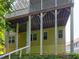 Backyard view of home's elevated porch with support beams and mature foliage at 490 Grand Teton Cir, Fayetteville, GA 30215
