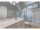 Bathroom featuring a white vanity, mirror, shower over tub with glass door at 490 Grand Teton Cir, Fayetteville, GA 30215
