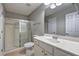 Bathroom featuring a shower with glass door, vanity with white countertop, and neutral walls at 490 Grand Teton Cir, Fayetteville, GA 30215