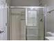 Bathroom shower featuring glass doors, storage niche, chrome hardware and clean white walls at 490 Grand Teton Cir, Fayetteville, GA 30215
