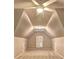 Bedroom with vaulted ceiling, carpet floors, ceiling fan, and bright natural light from the window at 490 Grand Teton Cir, Fayetteville, GA 30215