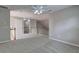 Spacious bonus room with gray carpeting, a ceiling fan, and access to the staircase at 490 Grand Teton Cir, Fayetteville, GA 30215