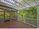 Open deck featuring wood floors, white railings, and a beautiful view of the surrounding trees at 490 Grand Teton Cir, Fayetteville, GA 30215