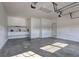 Bright garage featuring concrete flooring, overhead lighting, and convenient built-in shelving at 490 Grand Teton Cir, Fayetteville, GA 30215