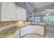 Bright kitchen featuring granite countertops, white cabinets, and stainless steel appliances at 490 Grand Teton Cir, Fayetteville, GA 30215