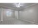 Living room featuring decorative columns, grey carpet, and a large window at 490 Grand Teton Cir, Fayetteville, GA 30215