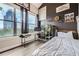 Modern bedroom with large window, desk, shelving, and black accent wall with white bedding for a bright space at 799 Hammond Dr # 427, Atlanta, GA 30328