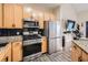 This kitchen features granite counters, stainless steel appliances, a gas range, and a refrigerator perfect for cooking at home at 799 Hammond Dr # 427, Atlanta, GA 30328