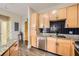 Efficient kitchen showcasing granite countertops, stainless steel appliances, black tiled backsplash, and wood flooring throughout at 799 Hammond Dr # 427, Atlanta, GA 30328