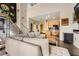 Open-concept living room featuring a gray sofa, wood floors, black accent wall and an adjacent kitchen with granite counters at 799 Hammond Dr # 427, Atlanta, GA 30328