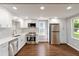 Bright kitchen with white cabinets, stainless steel appliances, and hardwood floors at 1441 Monteel Nw Dr, Atlanta, GA 30318