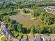 Community pond surrounded by lush trees and well-maintained homes, creating a serene and picturesque setting at 137 Hidden Lake Cir, Canton, GA 30114