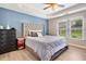 Comfortable bedroom with tray ceilings, a large bed, and a view of the outdoors at 137 Hidden Lake Cir, Canton, GA 30114