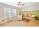 Cozy Bedroom with rocking chair, crib, and large window at 137 Hidden Lake Cir, Canton, GA 30114
