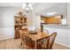 Dining room with wooden table, chandelier, and built-in china cabinet at 137 Hidden Lake Cir, Canton, GA 30114