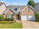 Charming brick home featuring a well-manicured lawn and an attached two-car garage at 137 Hidden Lake Cir, Canton, GA 30114