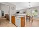 Well-lit kitchen and breakfast nook with wood cabinets, wood-look floors, and stainless steel sink at 137 Hidden Lake Cir, Canton, GA 30114