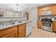 Bright kitchen with stainless steel oven and microwave, double basin sink, and wood cabinets at 137 Hidden Lake Cir, Canton, GA 30114