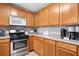 Spacious kitchen with stainless steel oven and microwave, light wood cabinets, and modern appliances at 137 Hidden Lake Cir, Canton, GA 30114
