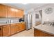 Well-lit kitchen with stainless steel fridge and oven, light wood cabinets, and double basin sink at 137 Hidden Lake Cir, Canton, GA 30114