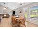 Well-lit living room with dining table, fan, and access to backyard at 137 Hidden Lake Cir, Canton, GA 30114